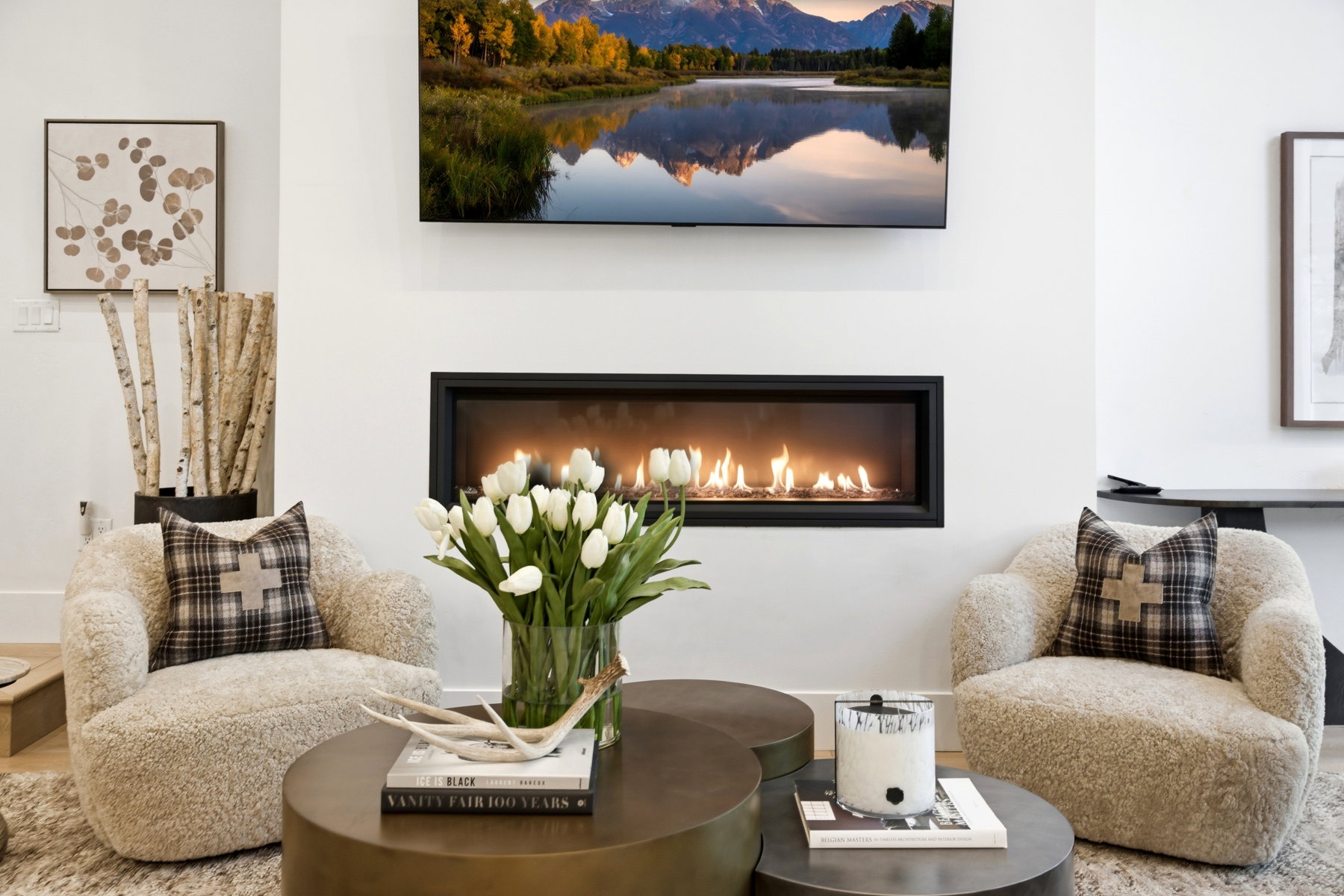 Contemporary linear fireplace with a black surround, integrated into a white wall