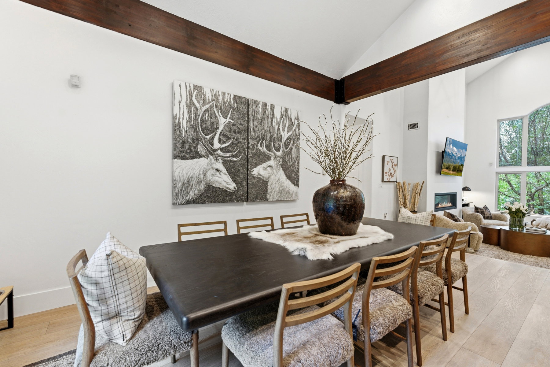 Vaulted ceilings with exposed wood beams define this dining area