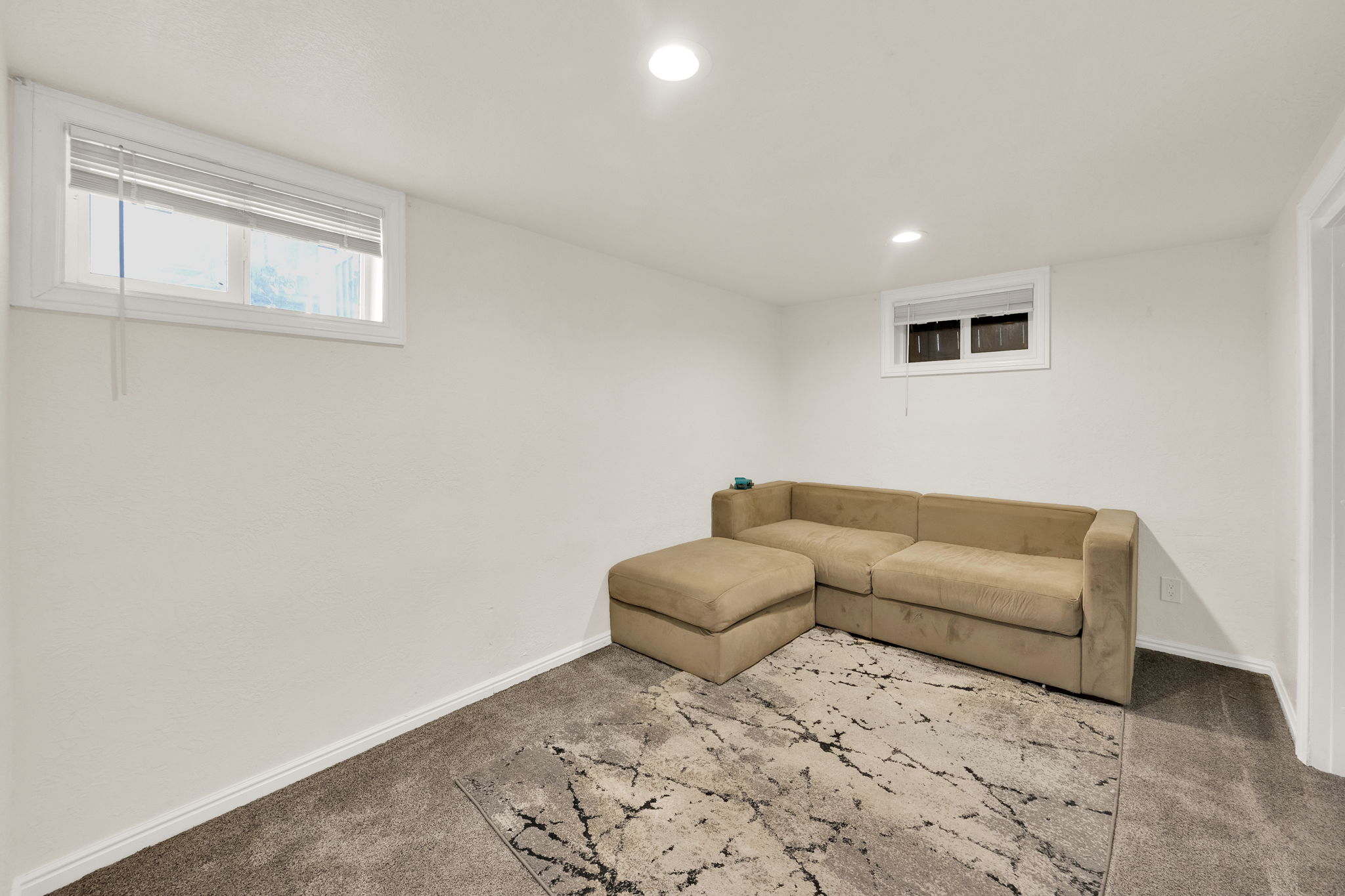 Room featuring recessed lighting, white walls, and light gray carpet flooring
