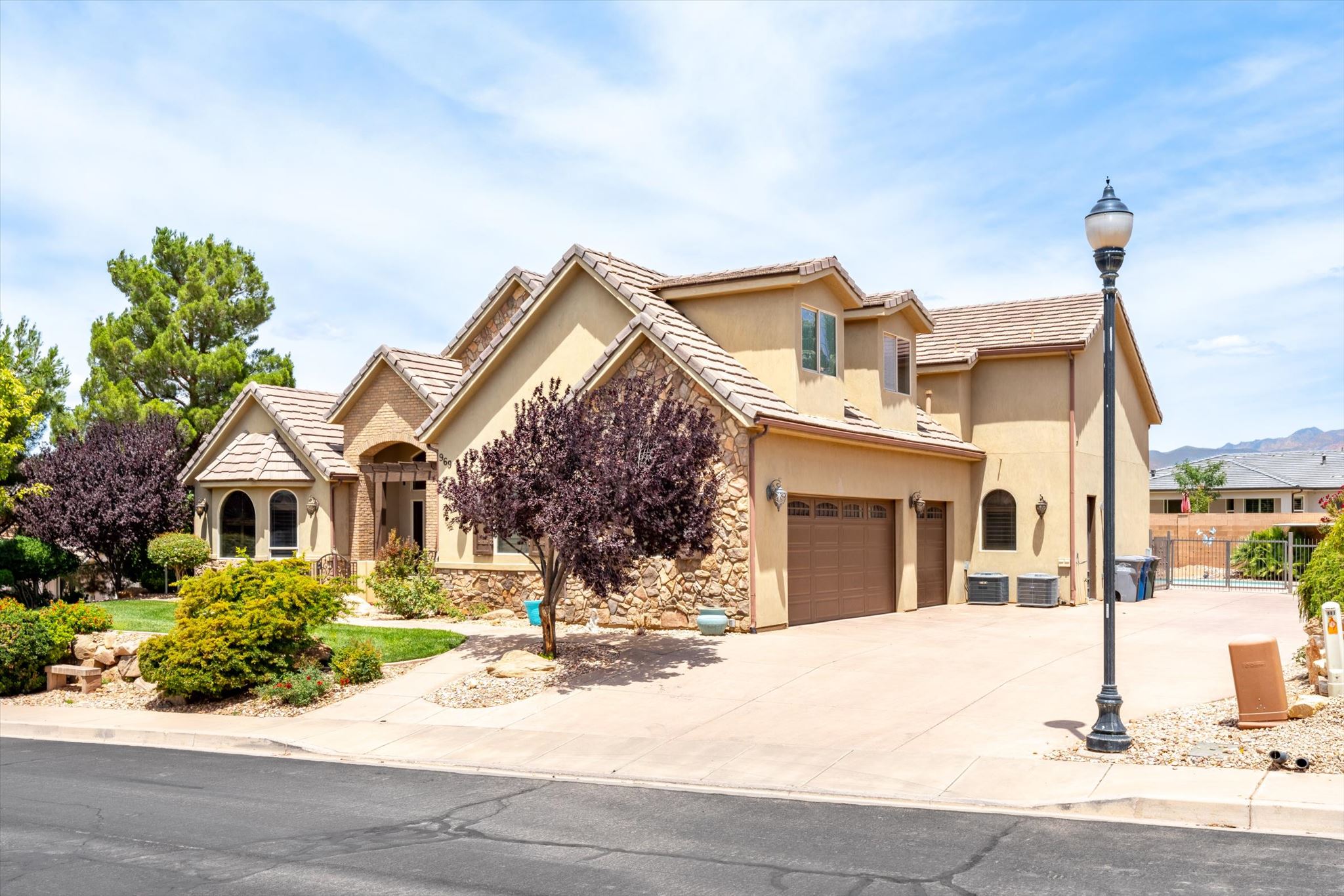 Warm stucco exterior with stone accents and multiple gables