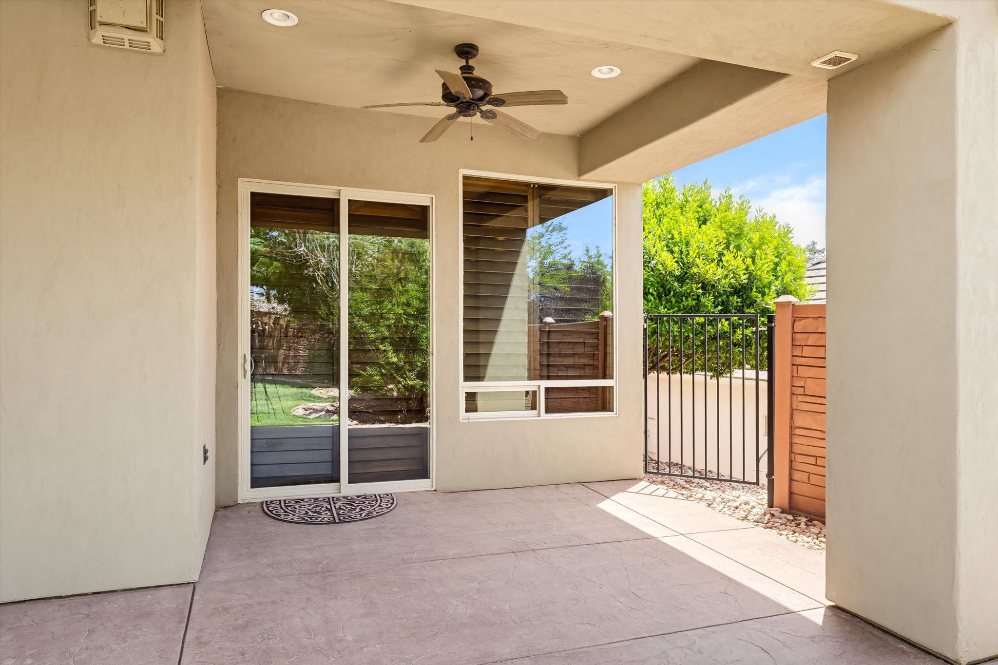Covered patio featuring stamped concrete flooring, a ceiling fan with integrated lighting, and recessed lighting