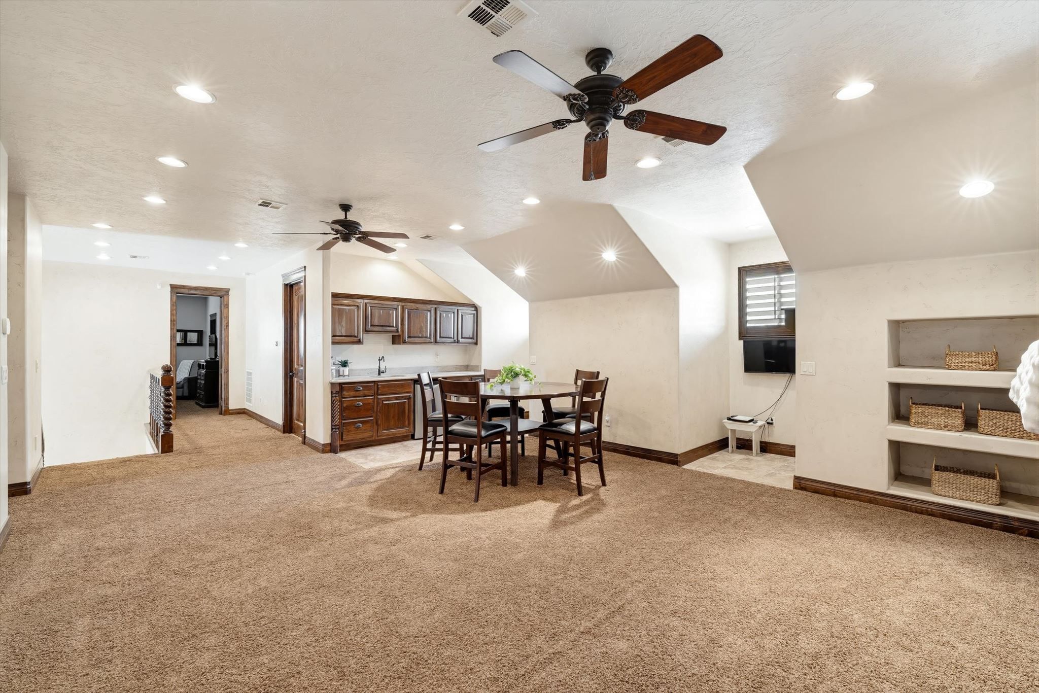 Spacious bonus room featuring plush carpet flooring, recessed lighting, and two ceiling fans