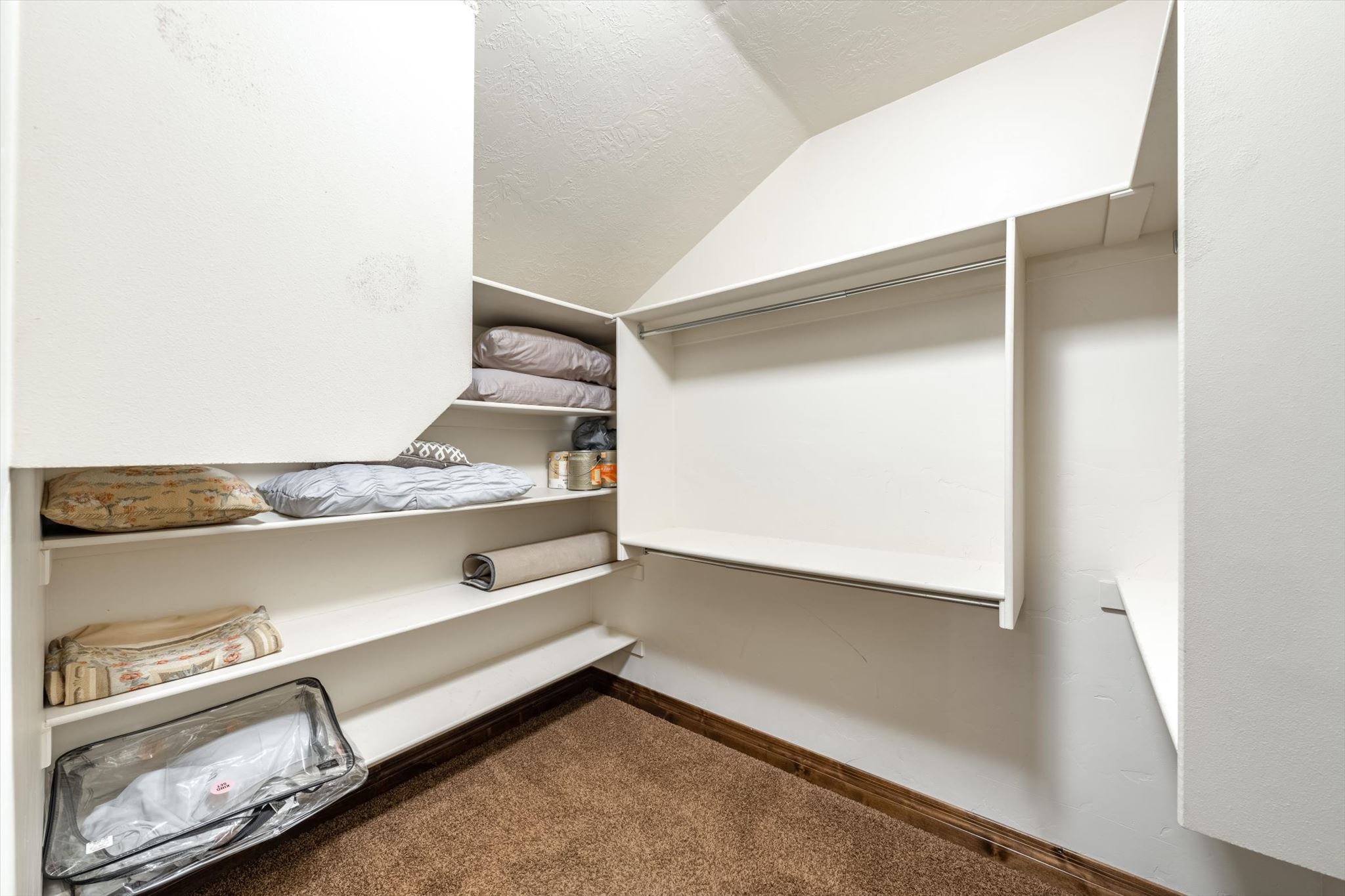 Built-in closet system featuring multiple shelving units and hanging rods