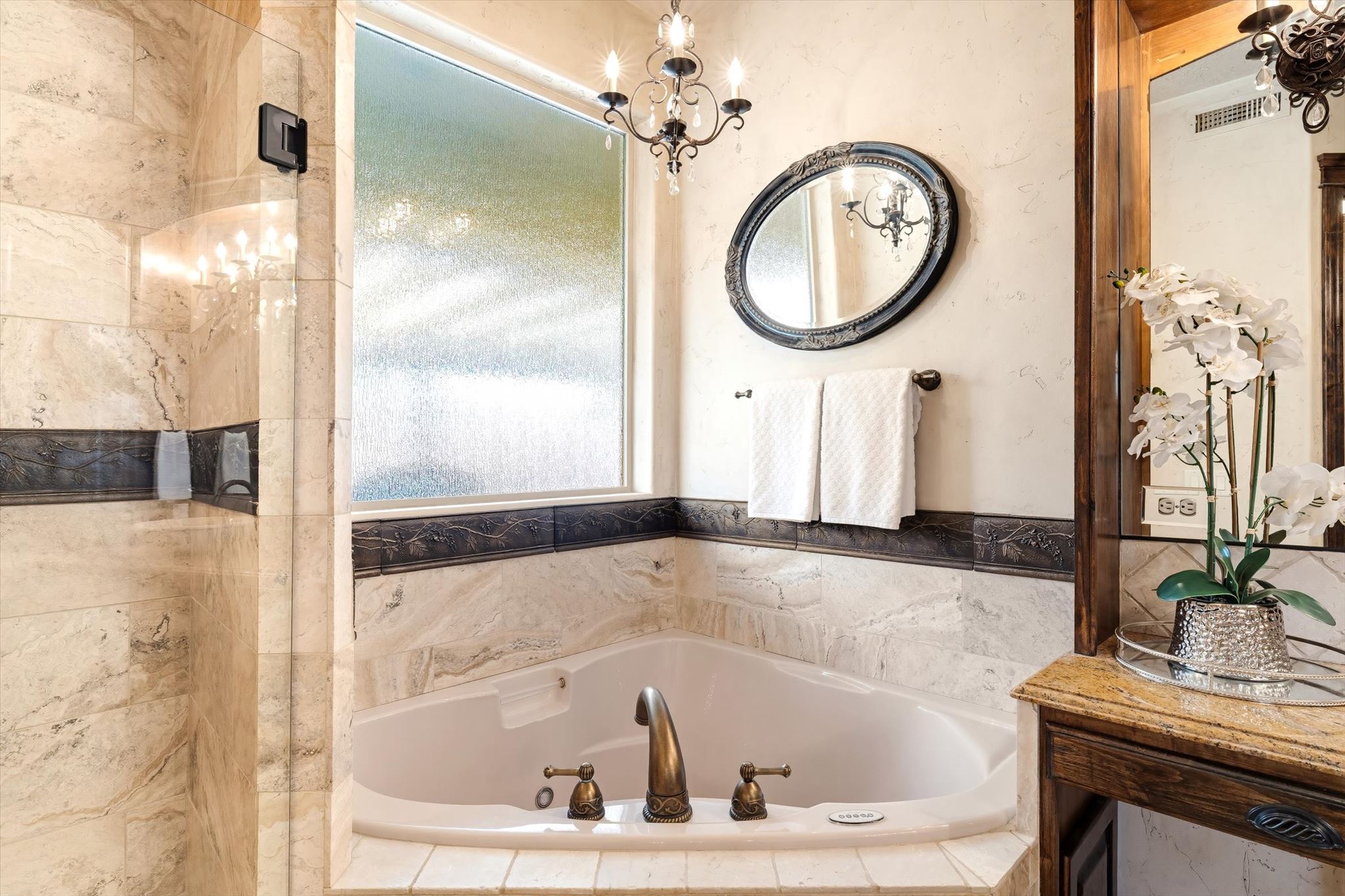 Corner soaking tub with bronze-finish fixtures