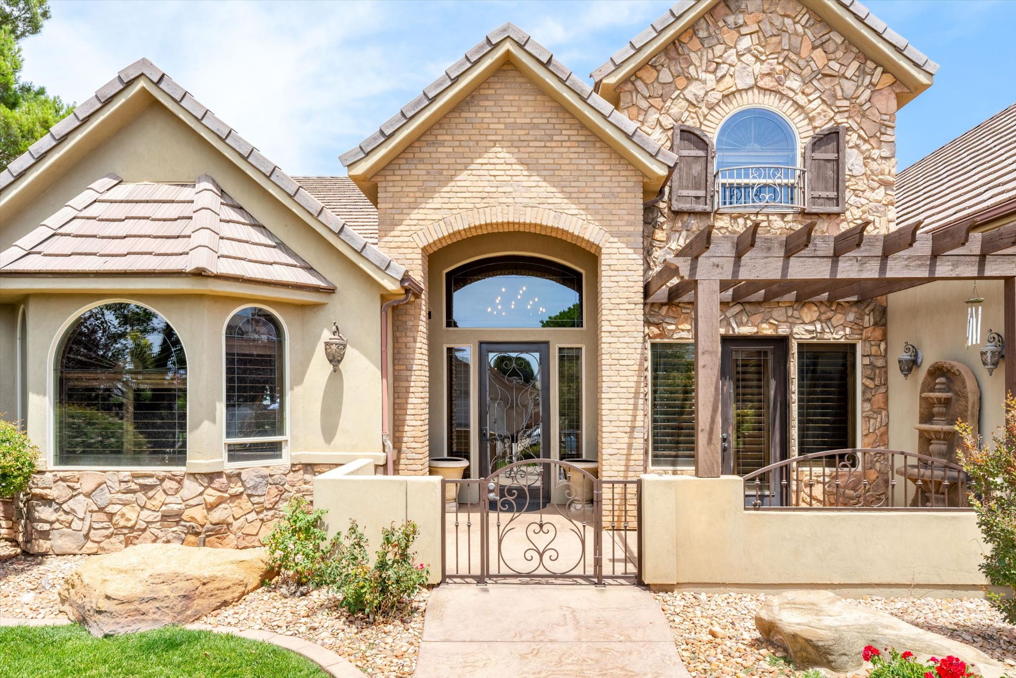 Stone and stucco exterior with brick accents