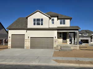 Contemporary two-story residence featuring a neutral exterior with board and batten siding and stone accents