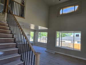 Grand staircase featuring wood-finish handrails and black metal balusters