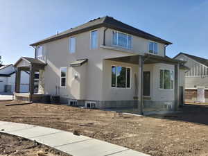 Two-story stucco residence featuring a covered front porch with stone accents