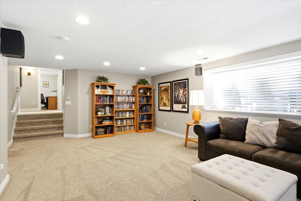 Other view of lower level living room. *There is a space stubbed for a 4th bathroom to the top right of the stairs