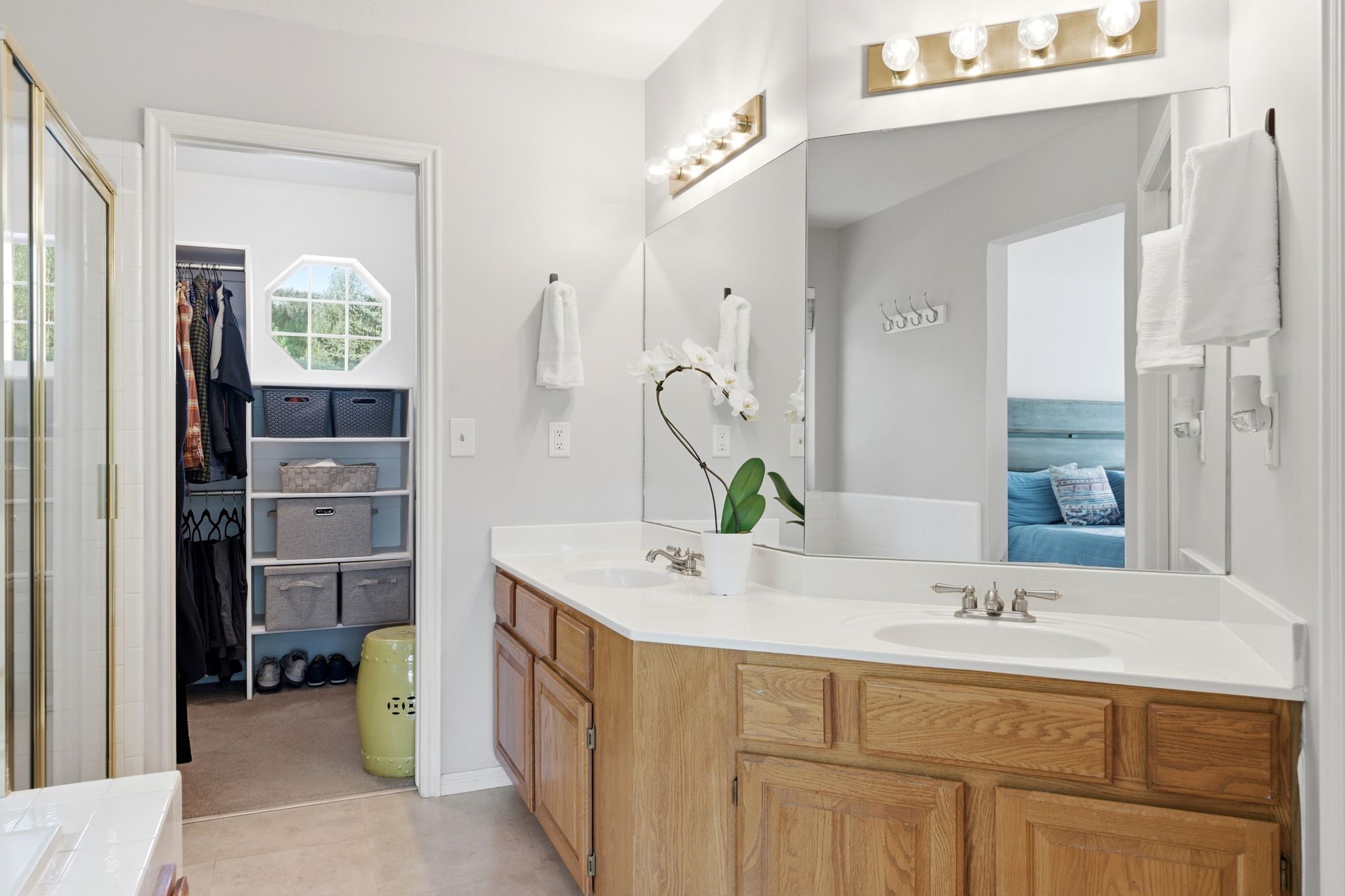 Upper Primary Bath with Double vanity with wood cabinetry and white countertops