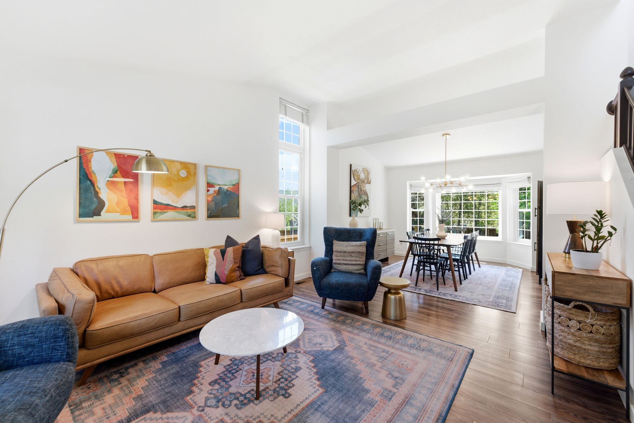 Open-concept living area featuring LVP flooring, high ceilings, and recessed lighting
