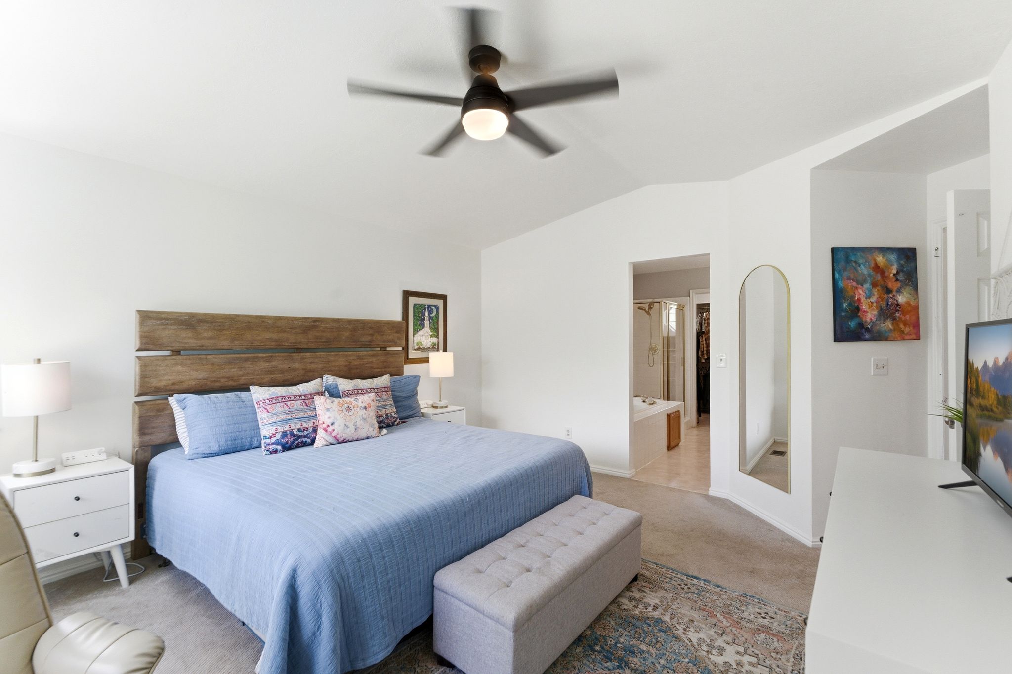 Upper Primary bedroom featuring light-colored carpeting, a vaulted ceiling, and a modern ceiling fan