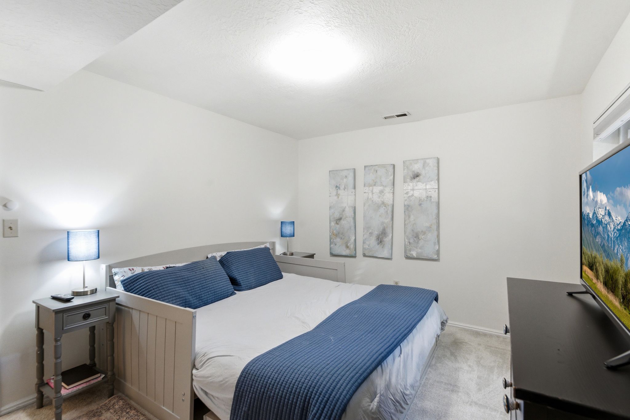Carpeted bedroom featuring white walls and a built-in recessed light fixture
