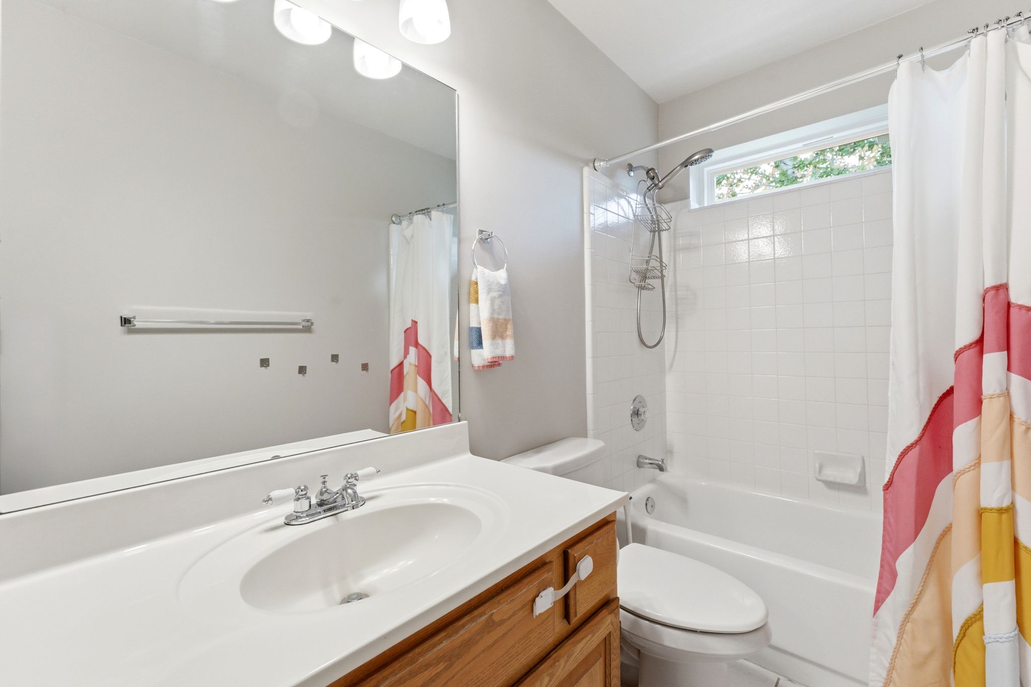 Upper Hall Full bathroom featuring a single vanity with wood cabinetry, an integrated sink, and a large wall mirror