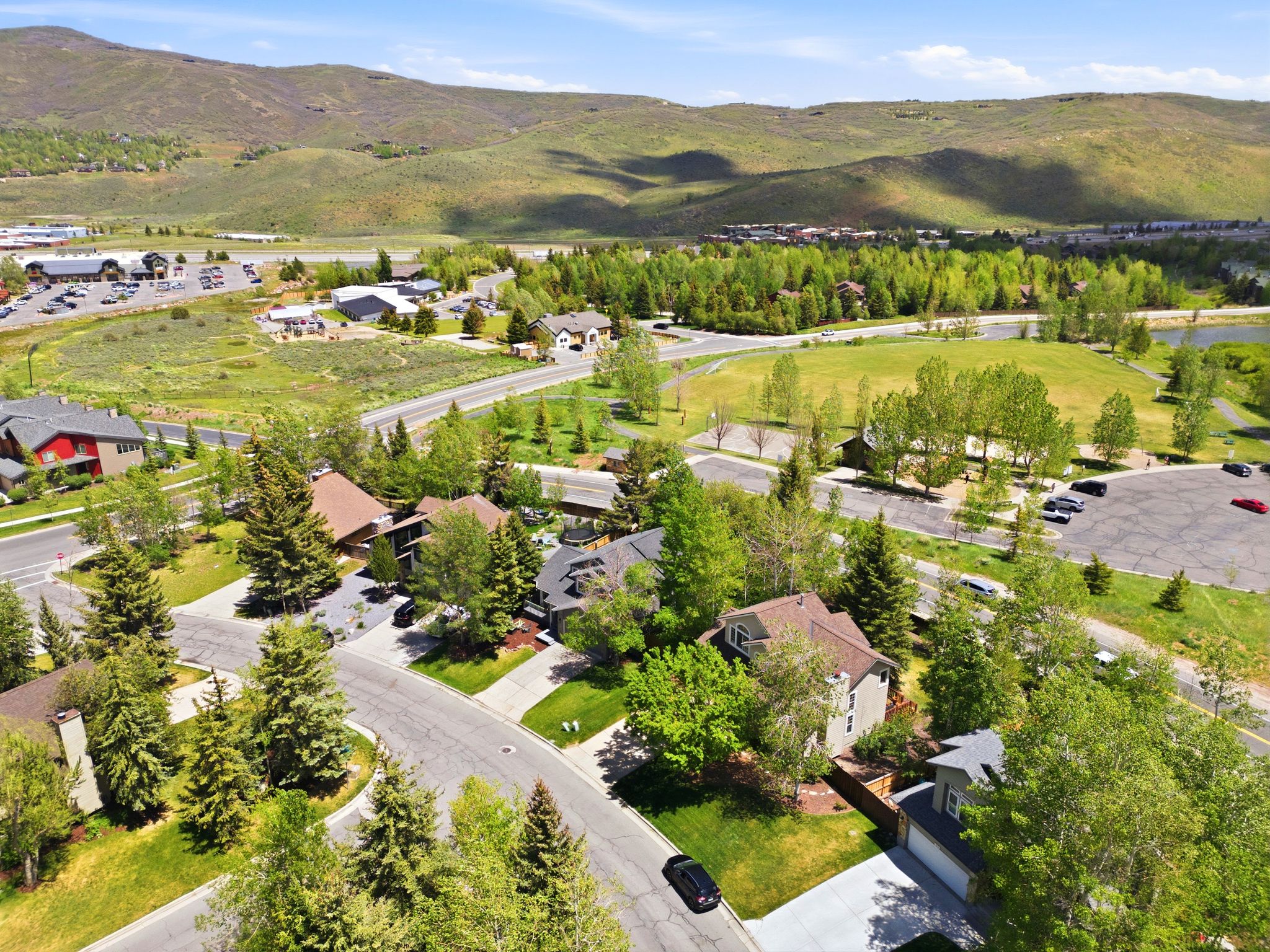 Aerial perspective showcasing a residential area close to Pinebrook Park  with varied home styles, ample green space, and mature trees