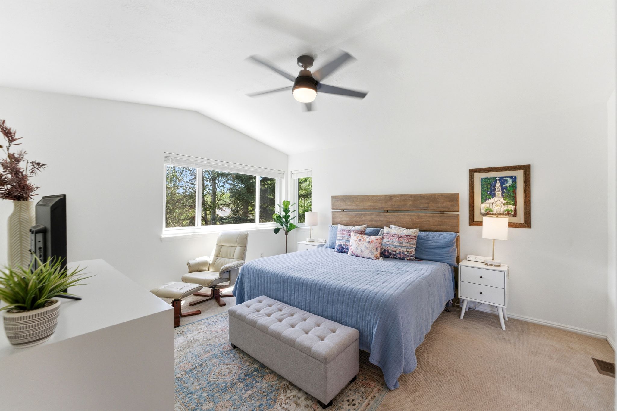 Upper Primary Bedroom featuring vaulted ceilings, a ceiling fan, broad windows, and soft carpet flooring