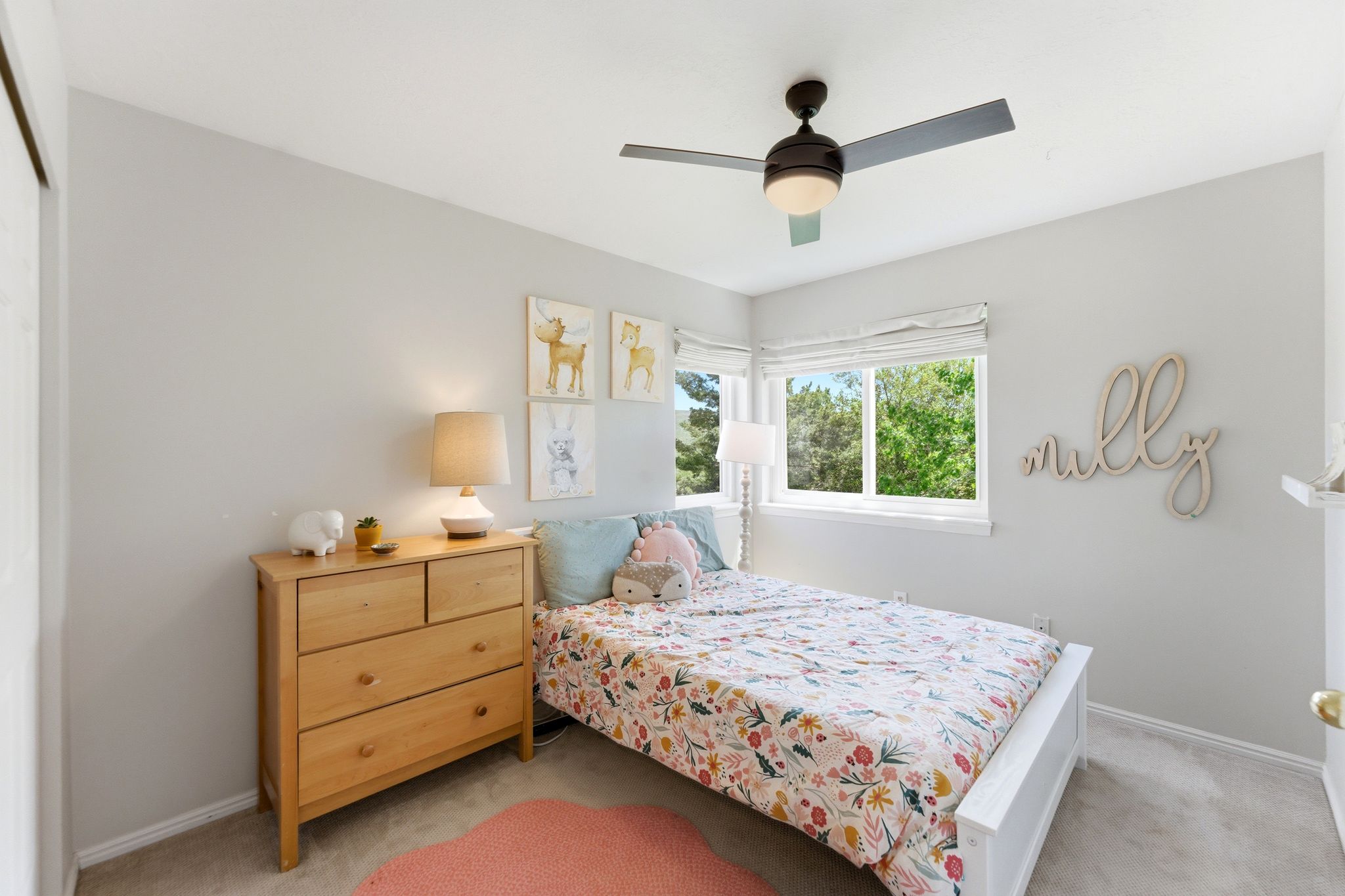 Upper Bedroom 1 featuring light-colored walls, carpet flooring, and a ceiling fan with integrated lighting