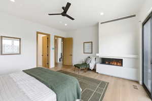 Bright interior with wood-finish flooring and a built-in linear fireplace