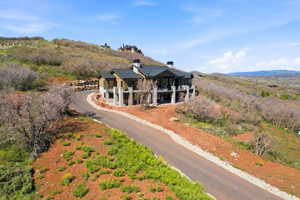 Contemporary hillside residence featuring a multi-level design with extensive balconies