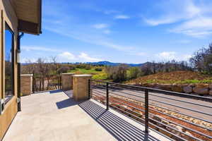 Expansive outdoor patio featuring large format tile flooring and contemporary metal railings