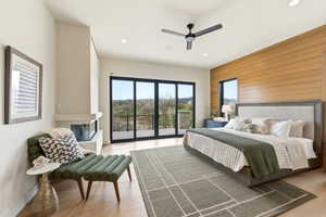 Hardwood-style flooring extends through this room featuring a horizontal wood-paneled accent wall