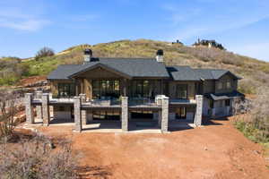 Hillside residence with extensive stone and wood siding