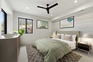 Spacious room featuring multiple windows with dark frames, recessed lighting, a ceiling fan, and an accent wall with a subtle horizontal texture