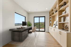 Contemporary interior featuring light wood-finish flooring, recessed lighting, and a neutral wall palette
