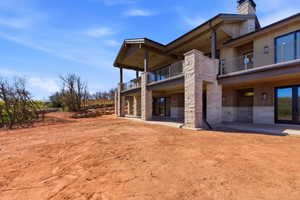 Exterior featuring stacked stone pillars, wood siding, and multiple balconies with cable railings