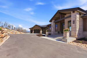 Stone and wood-clad exterior with an attached two-car garage
