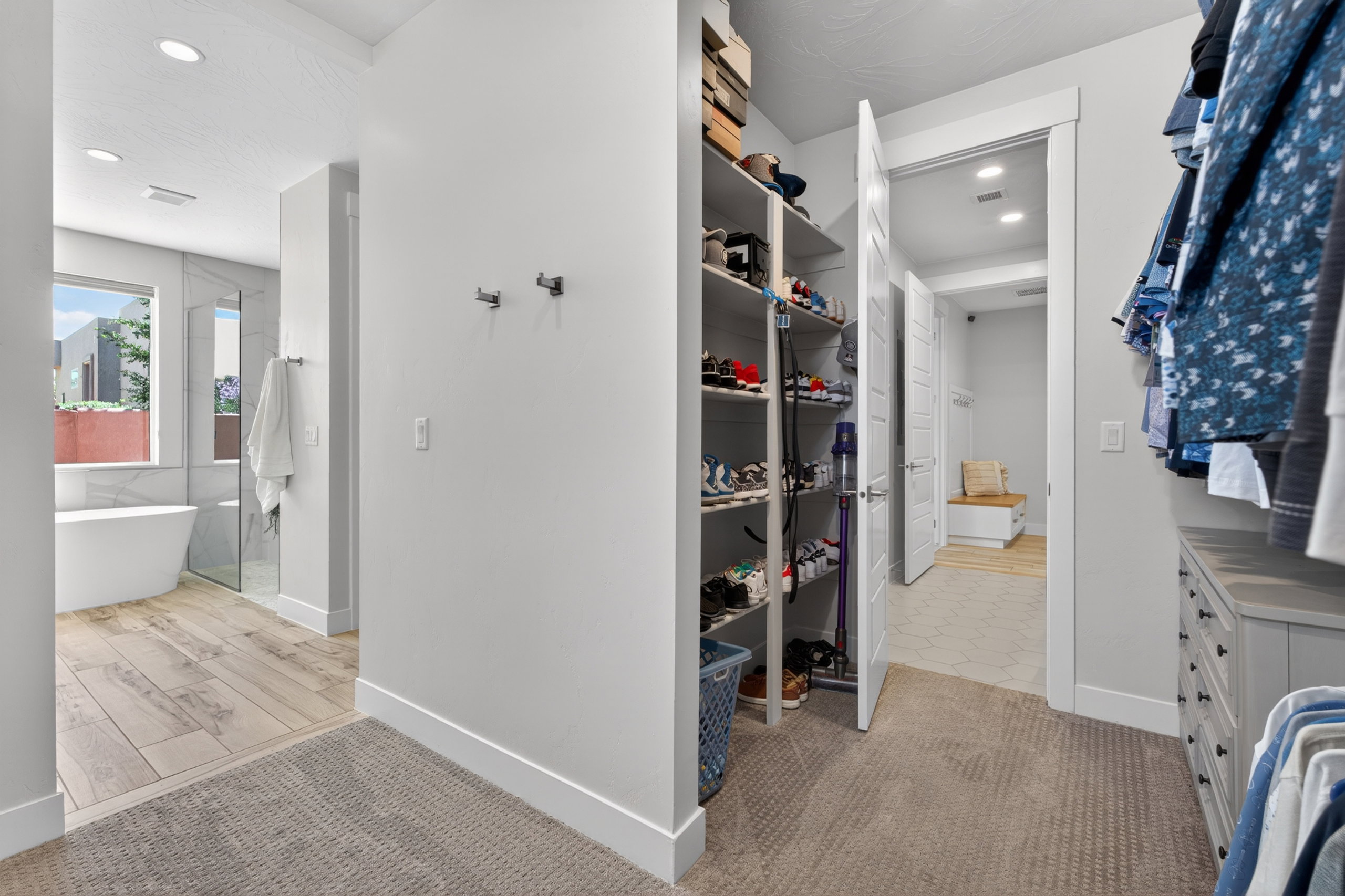Walk-in closet with built-in shelving and dresser cabinetry