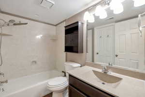 Bathroom featuring a tub/shower combination with a rain shower head, a wall-mounted medicine cabinet, and a vanity with an integrated sink and countertop