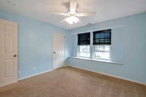 Carpeted room with light blue walls and white trim