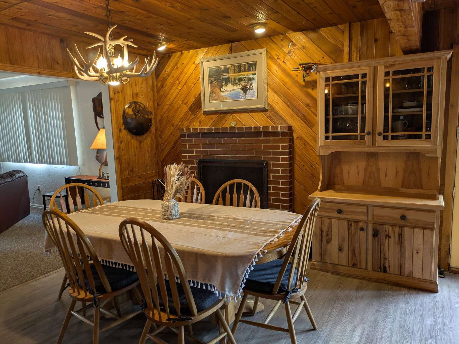 Dining area featuring wood-finish flooring and extensive wood paneling