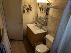 Bathroom vanity featuring an integrated sink with chrome faucet, wood-finish cabinetry, and a mirrored medicine cabinet
