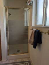 Shower enclosure with gold-toned framing and frosted glass panels