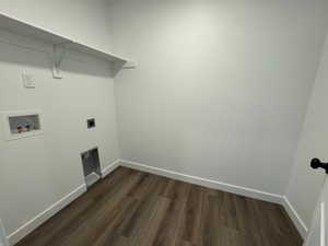 Laundry area featuring wood-finish flooring, white walls, and a white built-in shelf