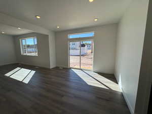 Spacious interior featuring wood-finish flooring, recessed lighting, and white baseboards