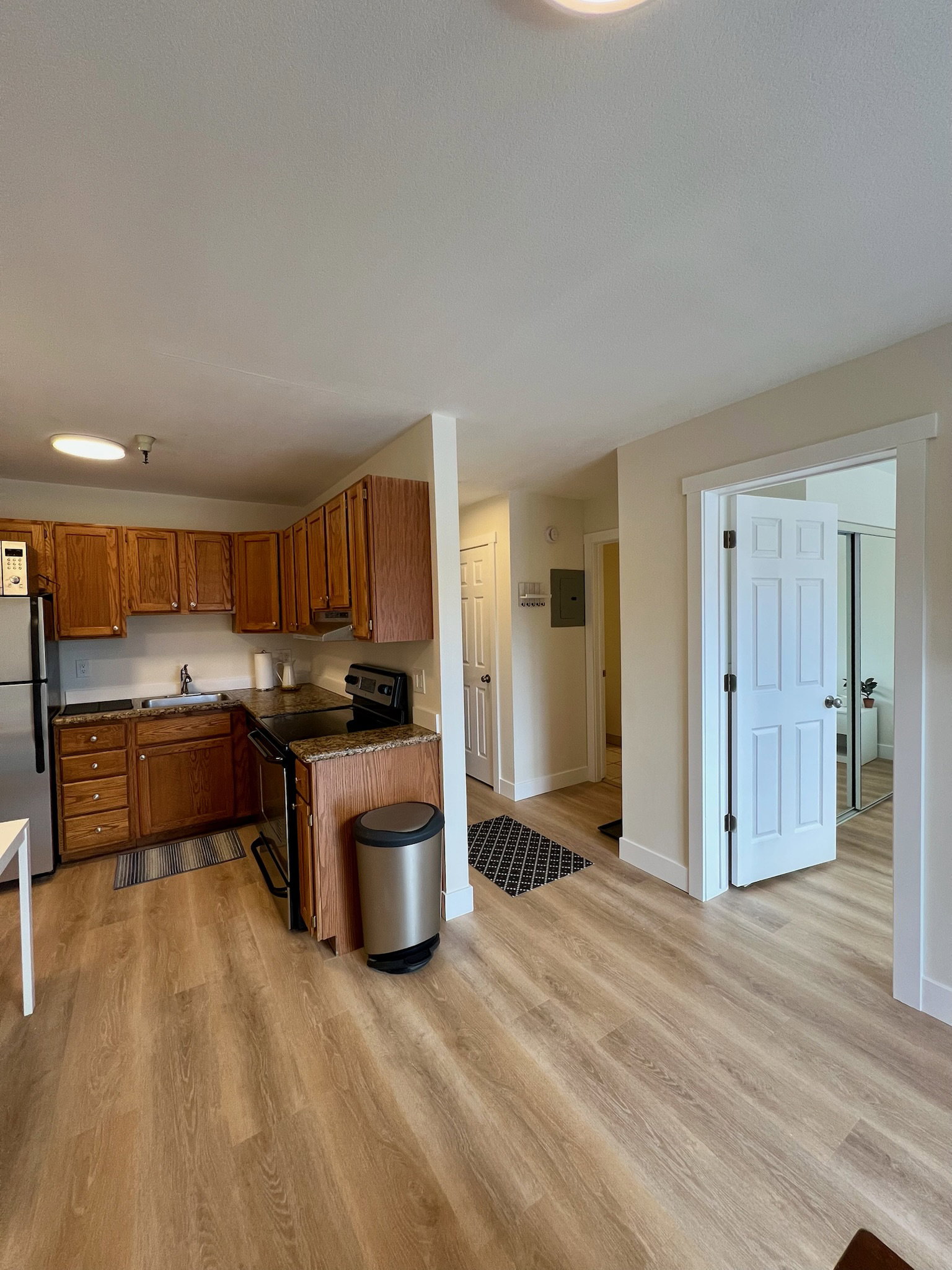 Functional kitchen with wood cabinetry, dark countertops, and stainless steel appliances
