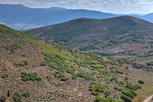 Expansive mountain landscape featuring varied elevations and natural foliage