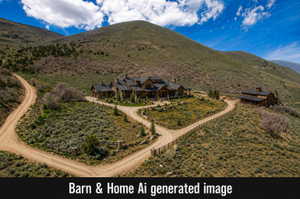 Expansive mountain property featuring a stone and timber residence, separate barn structure, and two distinct dirt access roads