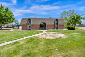 Brick exterior building with an arched entryway and matching arched windows