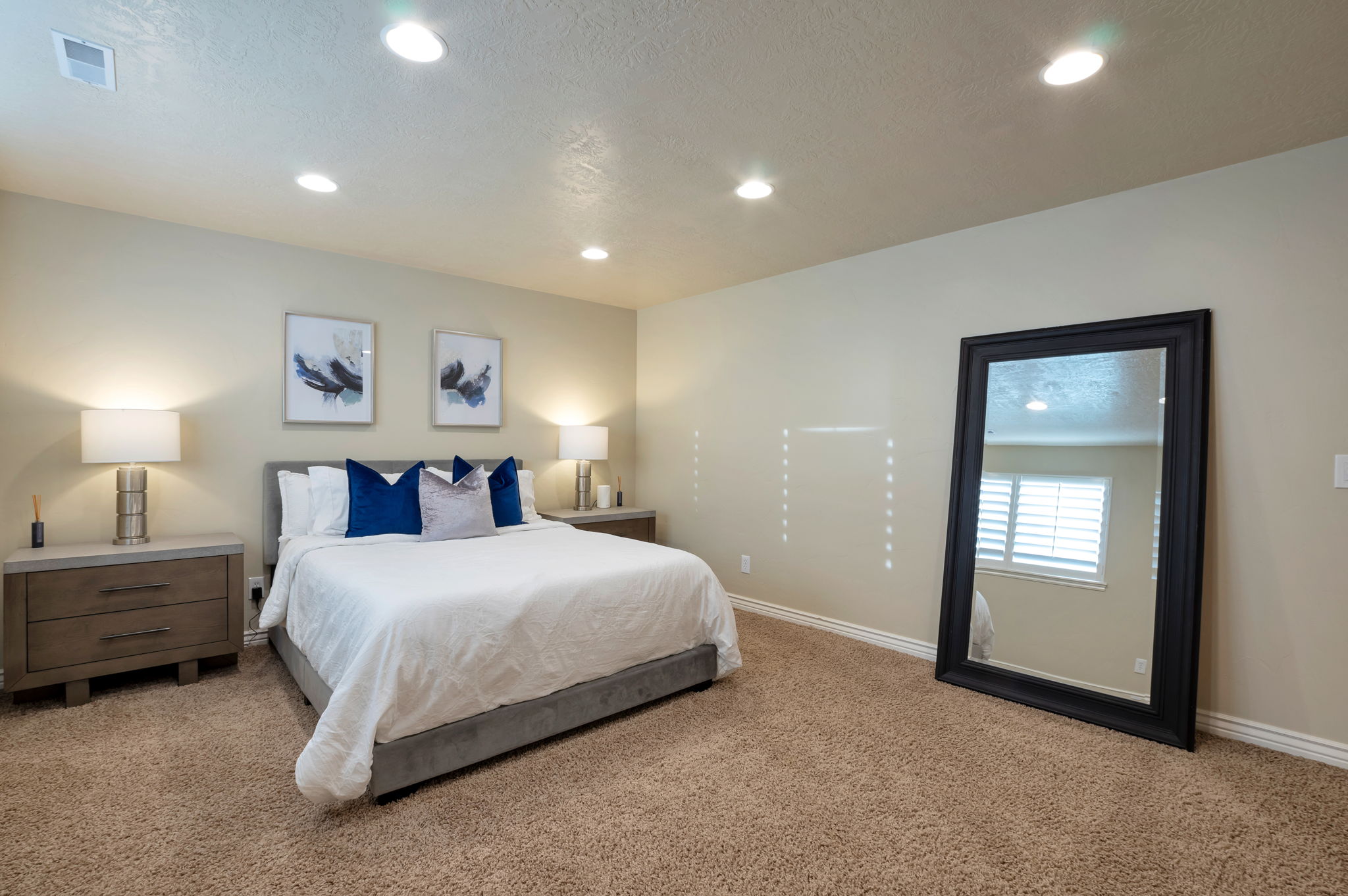 Large lower-level bedroom with generous proportions and abundant natural light.