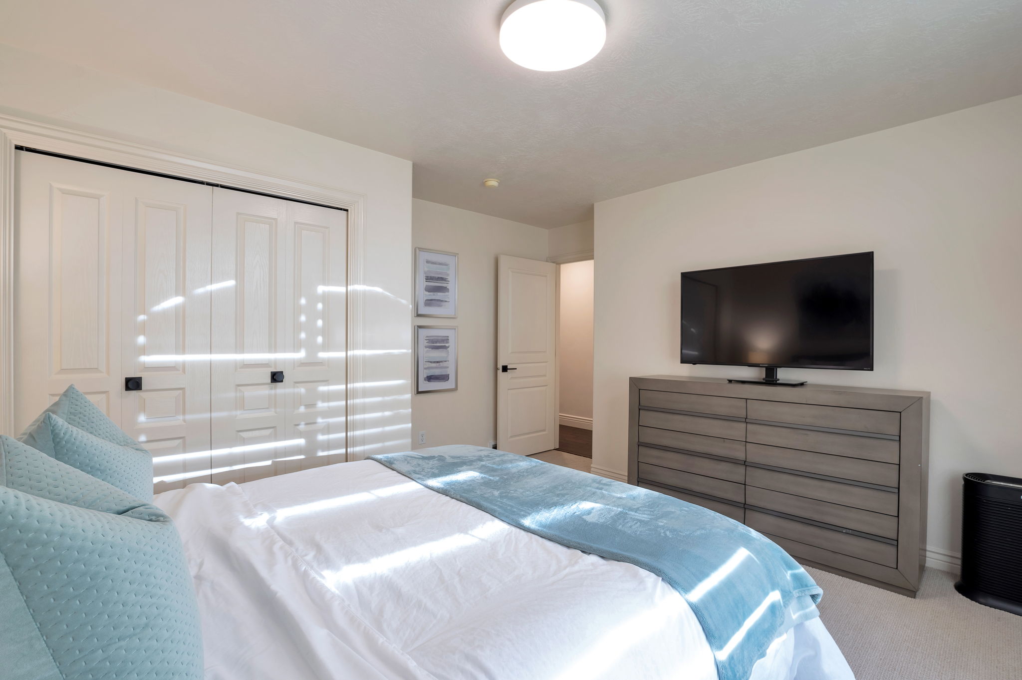 Spacious guest bedroom with neutral finishes and excellent closet space.