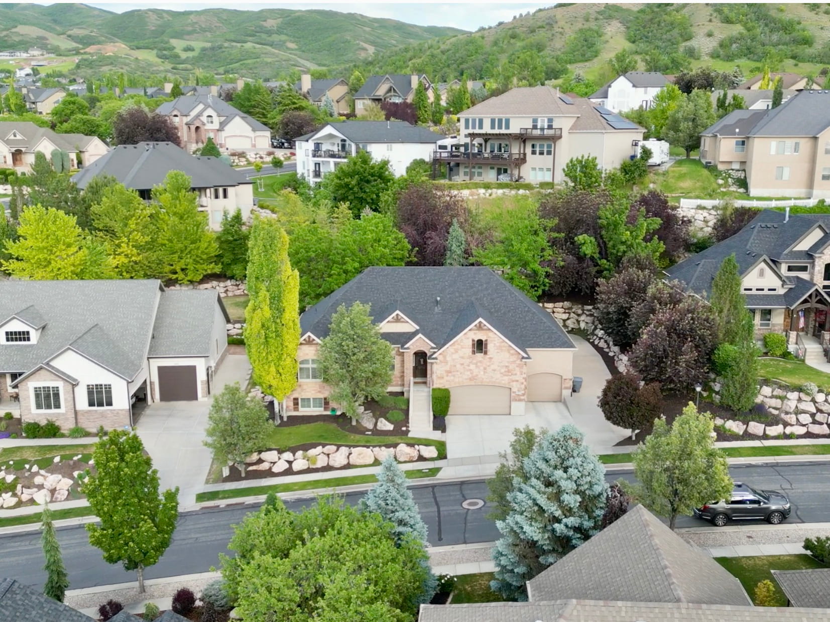 From the front of the home, enjoy long neighborhood views, beautiful tree-lined streets, and dramatic mountain backdrops that showcase the beauty of this sought-after community.