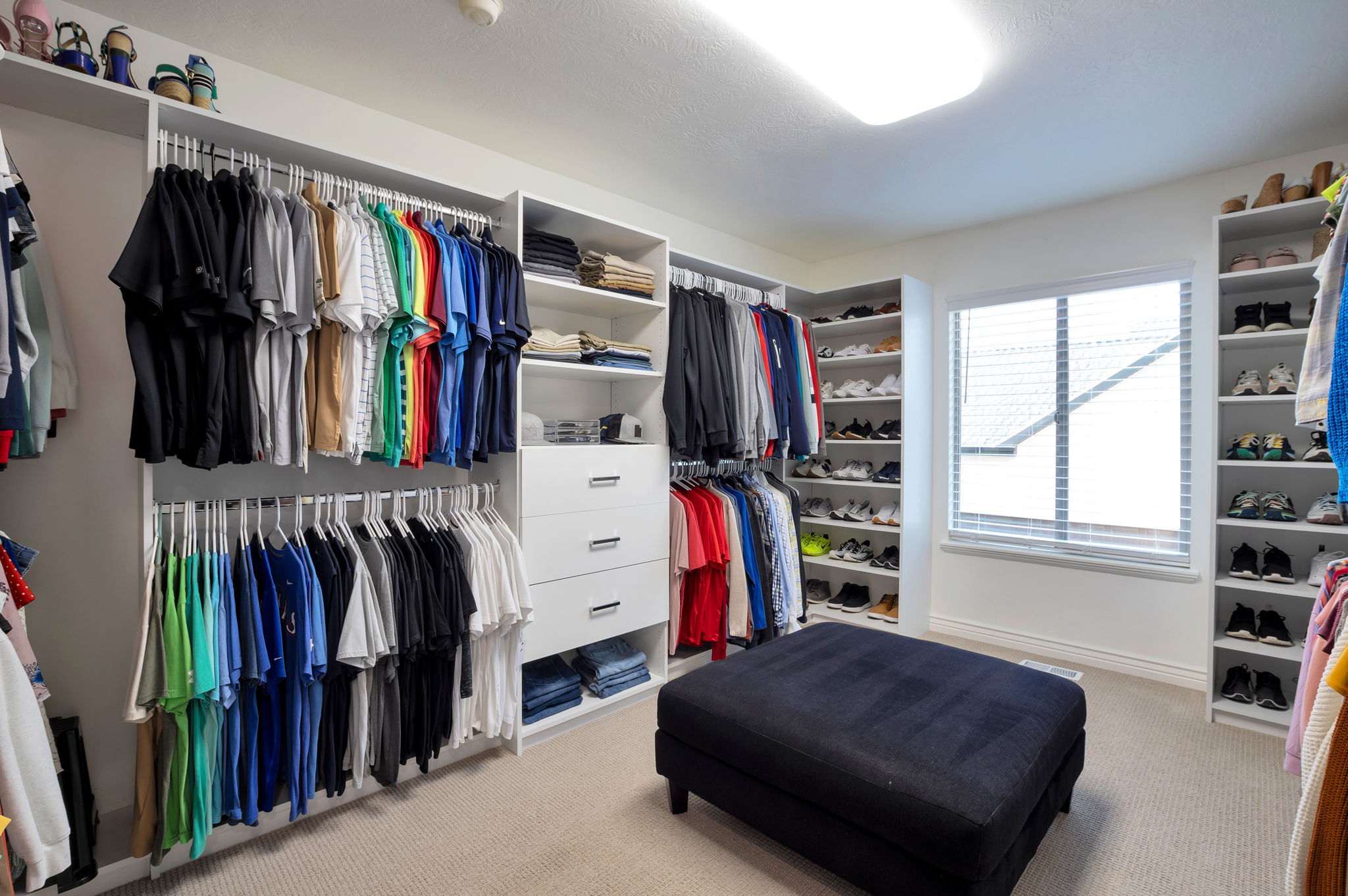 Custom walk-in closet with extensive built-ins designed to maximize organization and storage.