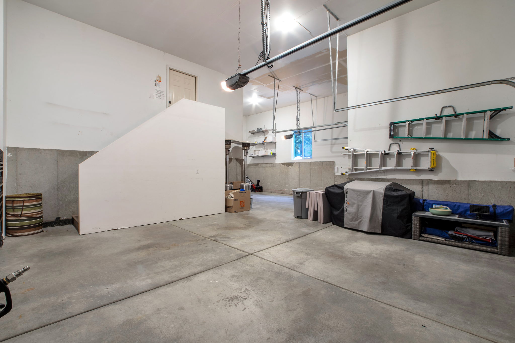 Rare oversized garage with exceptional ceiling height and extensive storage potential.