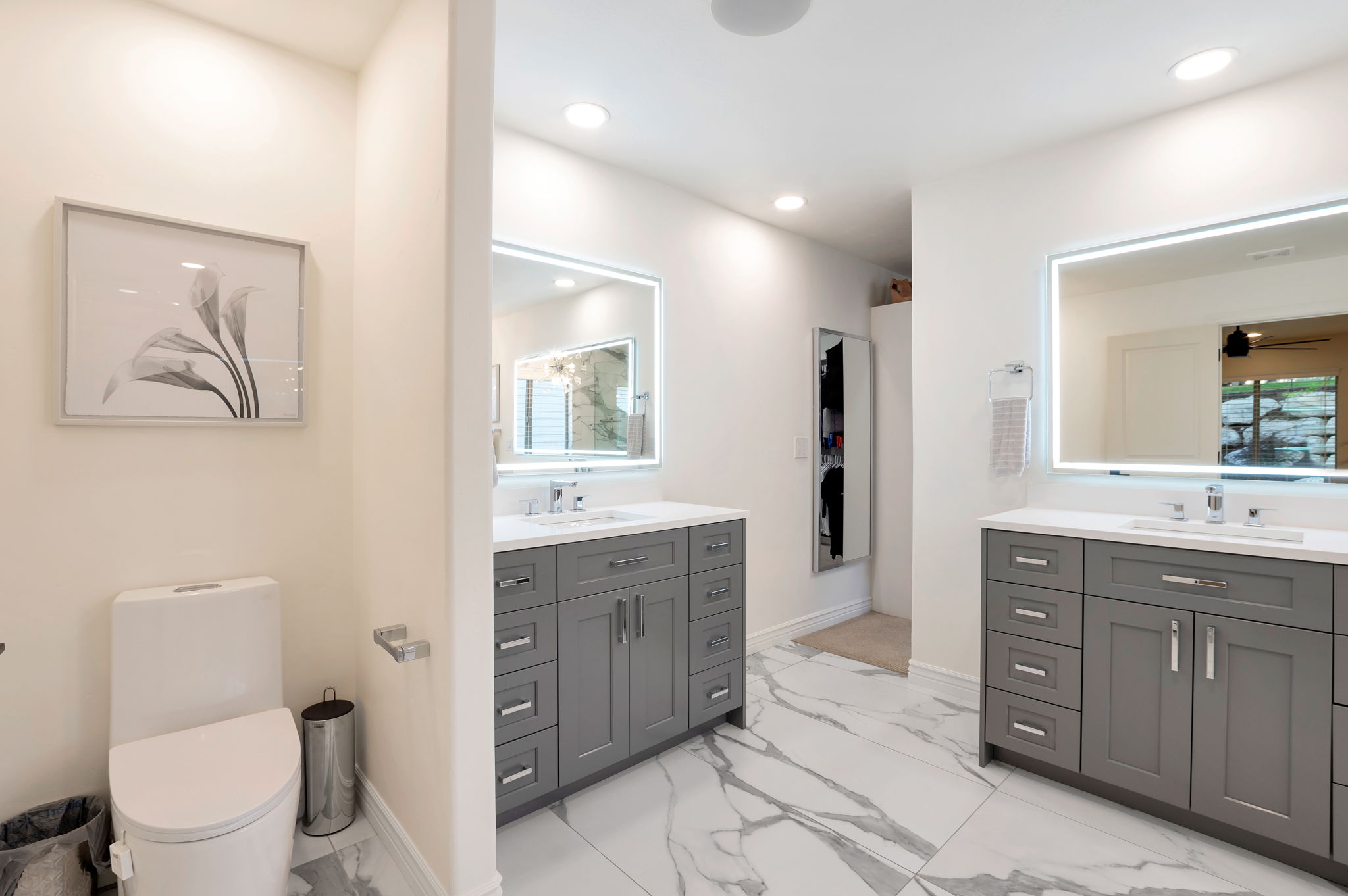 Dual vanities with abundant storage create a functional and elegant owner's bath.