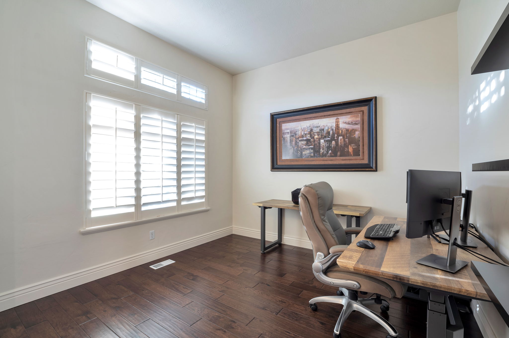 Dedicated home office with hardwood flooring and oversized windows—ideal for working from home.