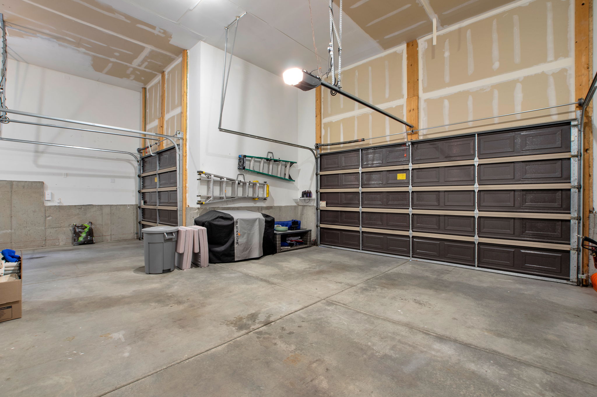 Extra-deep garage designed to accommodate vehicles, recreational equipment, and workshop space.